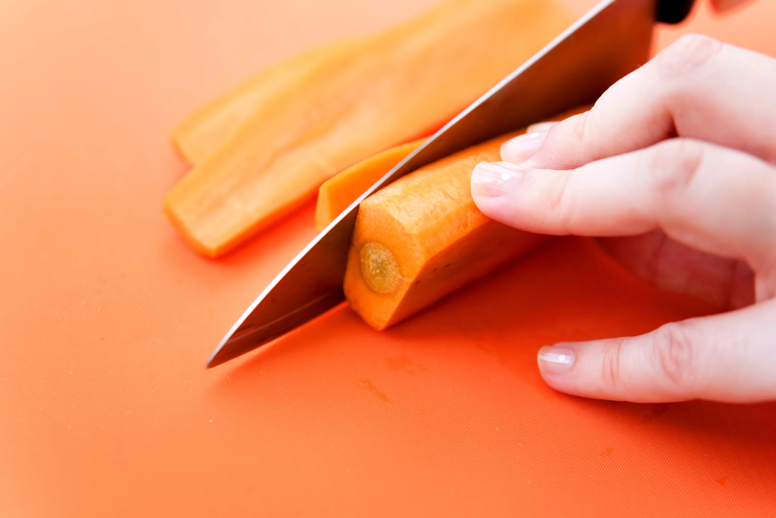 Sliced carrots with knife